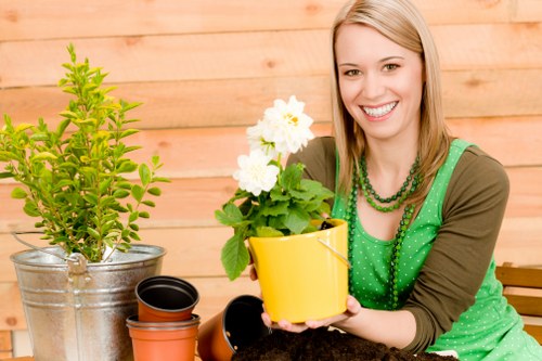 Trainer demonstrating safe tool use to gardening staff during training session